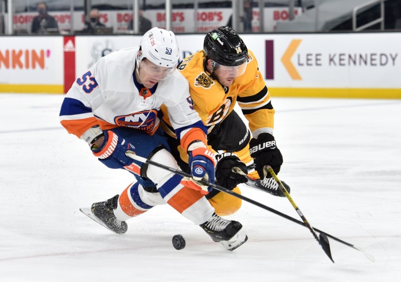 Apr 15, 2021; Boston, Massachusetts, USA; New York Islanders center Casey Cizikas (53) and Boston Bruins right wing Chris Wagner (14) battle for the puck during the first period at TD Garden. Mandatory Credit: Bob DeChiara-USA TODAY Sports