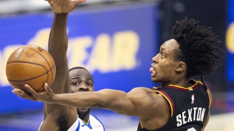 Apr 15, 2021; Cleveland, Ohio, USA; Cleveland Cavaliers guard Collin Sexton (2) lays the ball up past Golden State Warriors forward Draymond Green (23) during the first quarter at Rocket Mortgage FieldHouse. Mandatory Credit: Scott Galvin-USA TODAY Sports