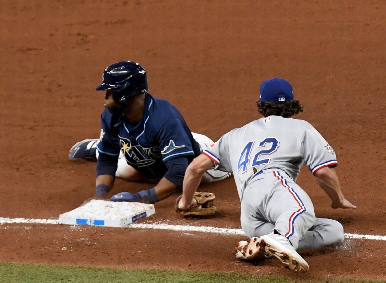 Apr 15, 2021; St. Petersburg, Florida, USA; Tampa Bay Rays outfielder Manuel Margot (13) steals third base as Texas Rangers infielder Charlie Culberson (2) attempts to tag him in the fourth inning  at Tropicana Field. Mandatory Credit: Jonathan Dyer-USA TODAY Sports