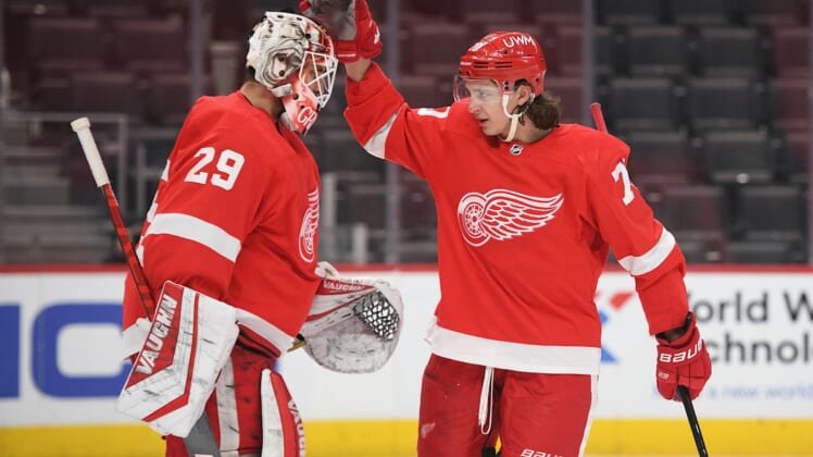 Apr 15, 2021; Detroit, Michigan, USA; Detroit Red Wings defenseman Troy Stecher (70) celebrates with goaltender Thomas Greiss (29) after the game against the Chicago Blackhawks at Little Caesars Arena. Mandatory Credit: Tim Fuller-USA TODAY Sports