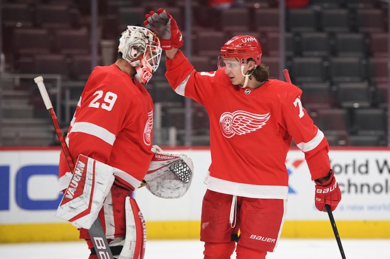 Apr 15, 2021; Detroit, Michigan, USA; Detroit Red Wings defenseman Troy Stecher (70) celebrates with goaltender Thomas Greiss (29) after the game against the Chicago Blackhawks at Little Caesars Arena. Mandatory Credit: Tim Fuller-USA TODAY Sports