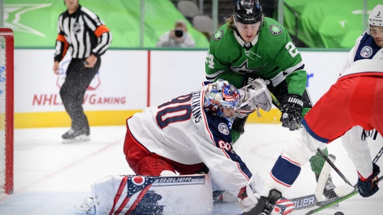 Apr 15, 2021; Dallas, Texas, USA; Columbus Blue Jackets goaltender Elvis Merzlikins (90) stops a shot by Dallas Stars left wing Roope Hintz (24) during the second period at the American Airlines Center. Mandatory Credit: Jerome Miron-USA TODAY Sports