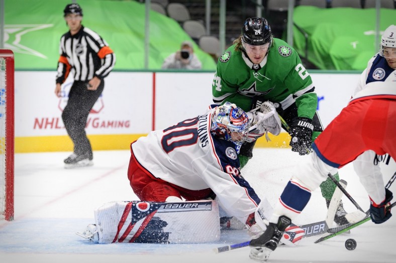 Apr 15, 2021; Dallas, Texas, USA; Columbus Blue Jackets goaltender Elvis Merzlikins (90) stops a shot by Dallas Stars left wing Roope Hintz (24) during the second period at the American Airlines Center. Mandatory Credit: Jerome Miron-USA TODAY Sports