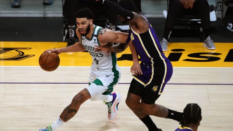 Apr 15, 2021; Los Angeles, California, USA; Boston Celtics forward Jayson Tatum (0) moves to the basket against Los Angeles Lakers guard Ben McLemore (7) during the first half at Staples Center. Mandatory Credit: Gary A. Vasquez-USA TODAY Sports