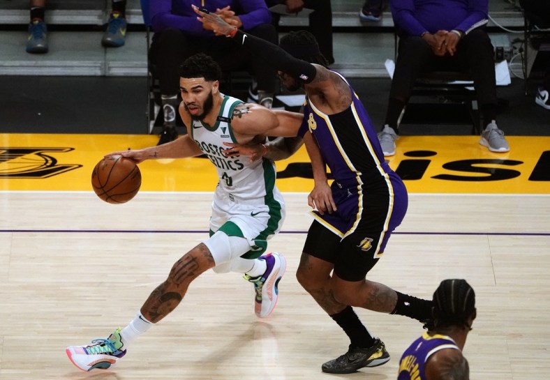 Apr 15, 2021; Los Angeles, California, USA; Boston Celtics forward Jayson Tatum (0) moves to the basket against Los Angeles Lakers guard Ben McLemore (7) during the first half at Staples Center. Mandatory Credit: Gary A. Vasquez-USA TODAY Sports