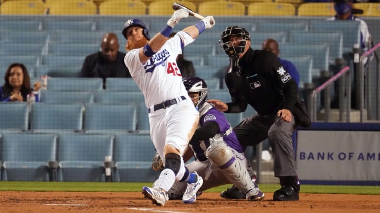 Apr 15, 2021; Los Angeles, California, USA; Los Angeles Dodgers third baseman Justin Turner follows through on a three-run home run in the third inning against the Colorado Rockies at Dodger Stadium. Mandatory Credit: Kirby Lee-USA TODAY Sports