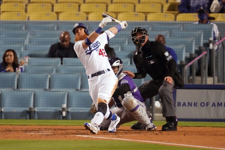 Apr 15, 2021; Los Angeles, California, USA; Los Angeles Dodgers third baseman Justin Turner follows through on a three-run home run in the third inning against the Colorado Rockies at Dodger Stadium. Mandatory Credit: Kirby Lee-USA TODAY Sports