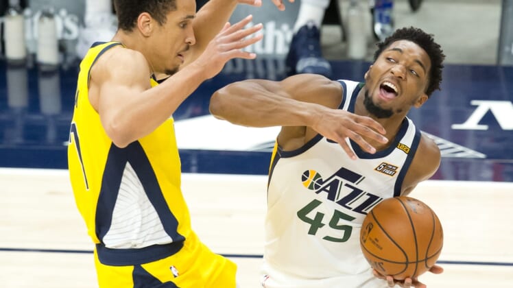 Apr 16, 2021; Salt Lake City, Utah, USA; Utah Jazz guard Donovan Mitchell (45) dribbles the ball against Indiana Pacers guard Malcolm Brogdon (7) during the first quarter at Vivint Smart Home Arena. Mandatory Credit: Russell Isabella-USA TODAY Sports