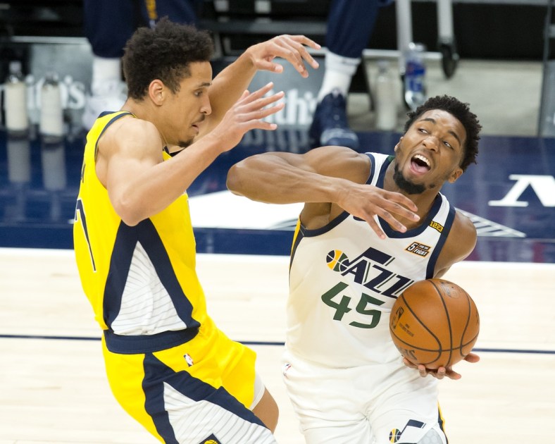 Apr 16, 2021; Salt Lake City, Utah, USA; Utah Jazz guard Donovan Mitchell (45) dribbles the ball against Indiana Pacers guard Malcolm Brogdon (7) during the first quarter at Vivint Smart Home Arena. Mandatory Credit: Russell Isabella-USA TODAY Sports