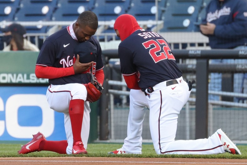 Apr 16, 2021; Washington, District of Columbia, USA; Washington Nationals center fielder Victor Robles (16) and Nationals left fielder Juan Soto (22) kneel in prayer prior to their game against the Arizona Diamondbacks at Nationals Park. Mandatory Credit: Geoff Burke-USA TODAY Sports