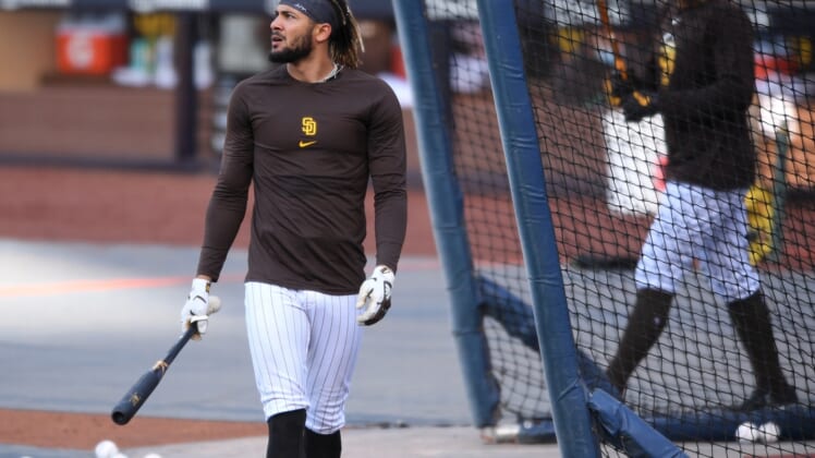 Apr 16, 2021; San Diego, California, USA; San Diego Padres shortstop Fernando Tatis Jr. (L) looks on during batting practice before the game against the Los Angeles Dodgers at Petco Park. Mandatory Credit: Orlando Ramirez-USA TODAY Sports