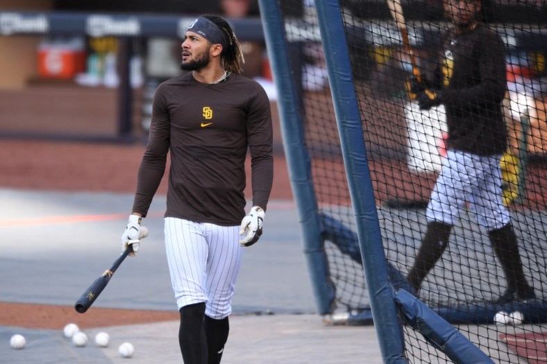 Apr 16, 2021; San Diego, California, USA; San Diego Padres shortstop Fernando Tatis Jr. (L) looks on during batting practice before the game against the Los Angeles Dodgers at Petco Park. Mandatory Credit: Orlando Ramirez-USA TODAY Sports