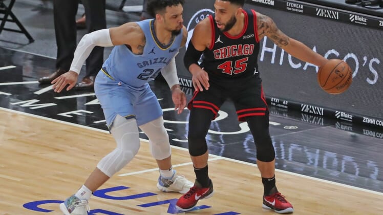 Apr 16, 2021; Chicago, Illinois, USA; Chicago Bulls guard Denzel Valentine (45) is defended by Memphis Grizzlies forward Dillon Brooks (24) during the second quarter at the United Center. Mandatory Credit: Dennis Wierzbicki-USA TODAY Sports