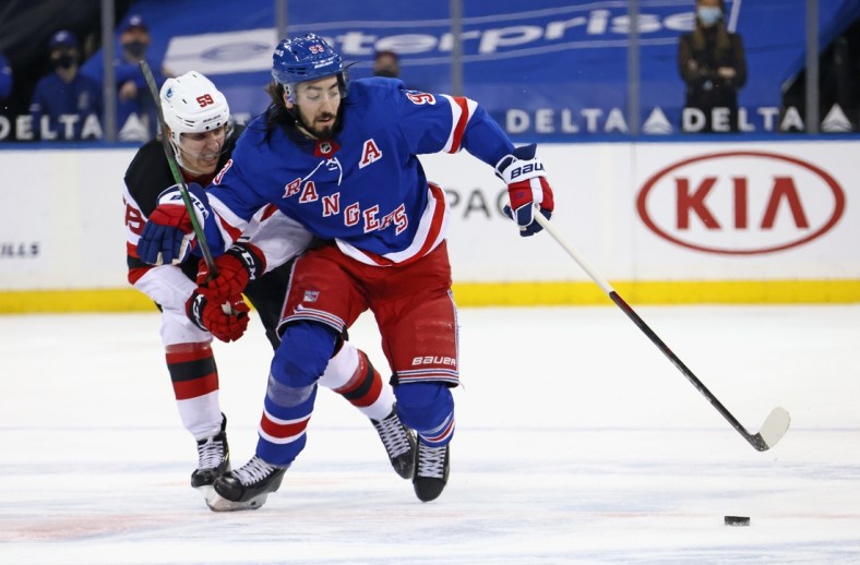 Apr 17, 2021; New York, New York, USA; anne Kuokkanen #59 of the New Jersey Devils holds back Mika Zibanejad #93 of the New York Rangers during the second period at Madison Square Garden. Mandatory Credit:  POOL PHOTOS-USA TODAY Sports