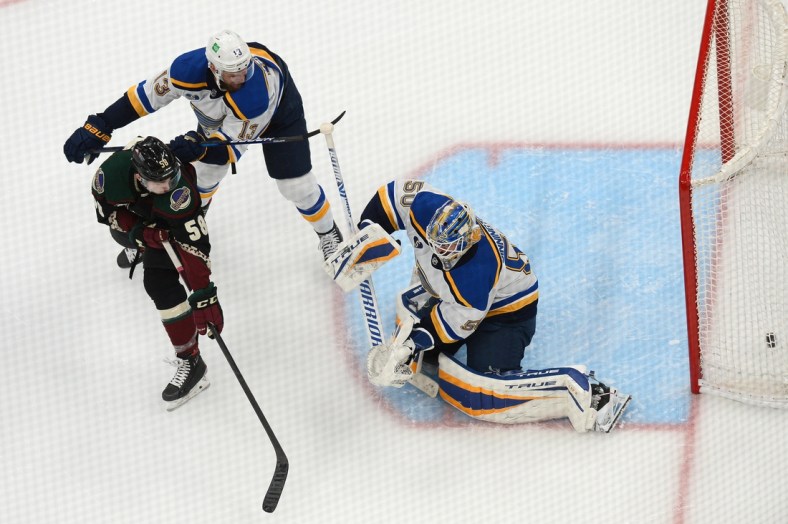Apr 17, 2021; Glendale, Arizona, USA; Arizona Coyotes left wing Michael Bunting (58) deflects a shot by St. Louis Blues goaltender Jordan Binnington (50) for a goal during the third period at Gila River Arena. Mandatory Credit: Joe Camporeale-USA TODAY Sports