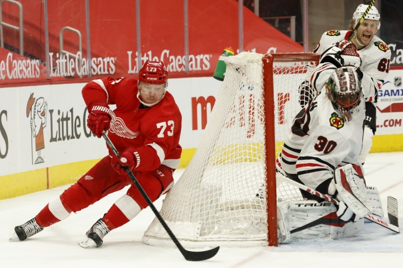 Apr 17, 2021; Detroit, Michigan, USA; Detroit Red Wings left wing Adam Erne (73) skates with the puck around the goal of Chicago Blackhawks goaltender Malcolm Subban (30) in the second period at Little Caesars Arena. Mandatory Credit: Rick Osentoski-USA TODAY Sports