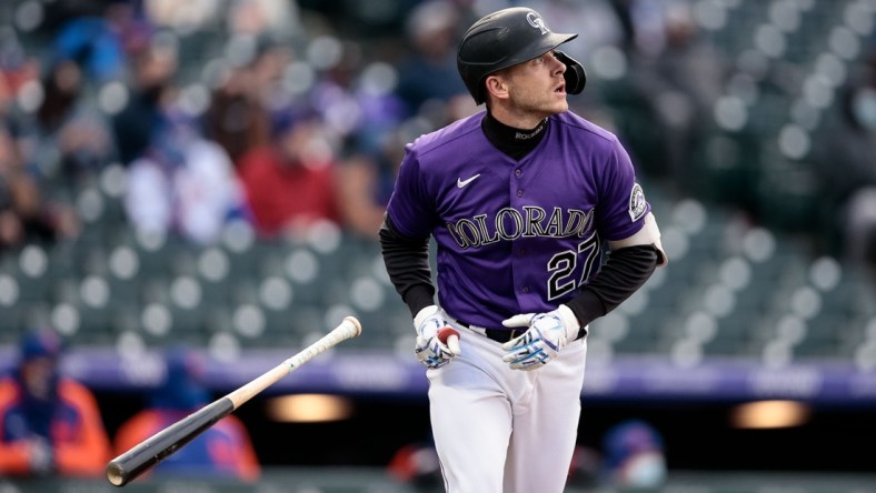 Apr 17, 2021; Denver, Colorado, USA; Colorado Rockies shortstop Trevor Story (27) watches his ball on a sacrifice fly RBI in the first inning against the New York Mets at Coors Field. Mandatory Credit: Isaiah J. Downing-USA TODAY Sports