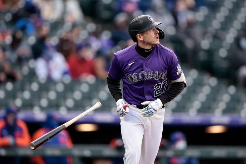 Apr 17, 2021; Denver, Colorado, USA; Colorado Rockies shortstop Trevor Story (27) watches his ball on a sacrifice fly RBI in the first inning against the New York Mets at Coors Field. Mandatory Credit: Isaiah J. Downing-USA TODAY Sports