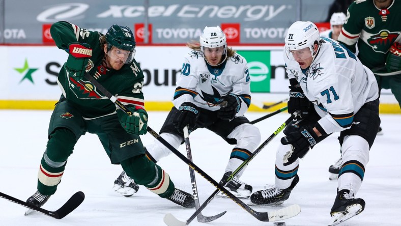 Apr 17, 2021; Saint Paul, Minnesota, USA; Minnesota Wild defenseman Jonas Brodin (25) attempts to shoot the puck as San Jose Sharks defenseman Nikolai Knyzhov (71) defends him during the second period at Xcel Energy Center. Mandatory Credit: Harrison Barden-USA TODAY Sports