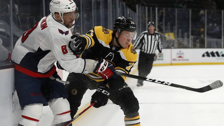 Apr 18, 2021; Boston, Massachusetts, USA; Boston Bruins defenseman Charlie McAvoy (73) collides with Washington Capitals left wing Alex Ovechkin (8) during the first period at TD Garden. Mandatory Credit: Winslow Townson-USA TODAY Sports