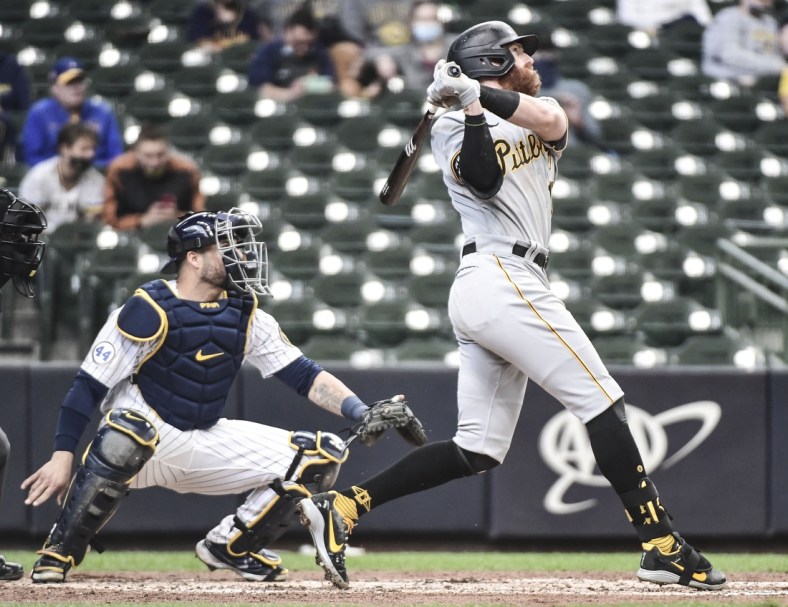 Apr 18, 2021; Milwaukee, Wisconsin, USA; Pittsburgh Pirates third baseman Colin Moran (19) hits a three-run home run in the third inning as Milwaukee Brewers catcher Manny Pina (9) watches at American Family Field. Mandatory Credit: Benny Sieu-USA TODAY Sports