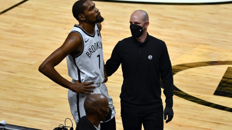 Apr 18, 2021; Miami, Florida, USA; Brooklyn Nets forward Kevin Durant (7) gets examined off the court during the first half of a game against the Miami Heat at American Airlines Arena. Mandatory Credit: Jim Rassol-USA TODAY Sports