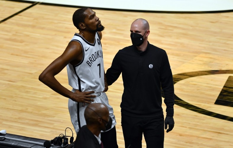 Apr 18, 2021; Miami, Florida, USA; Brooklyn Nets forward Kevin Durant (7) gets examined off the court during the first half of a game against the Miami Heat at American Airlines Arena. Mandatory Credit: Jim Rassol-USA TODAY Sports