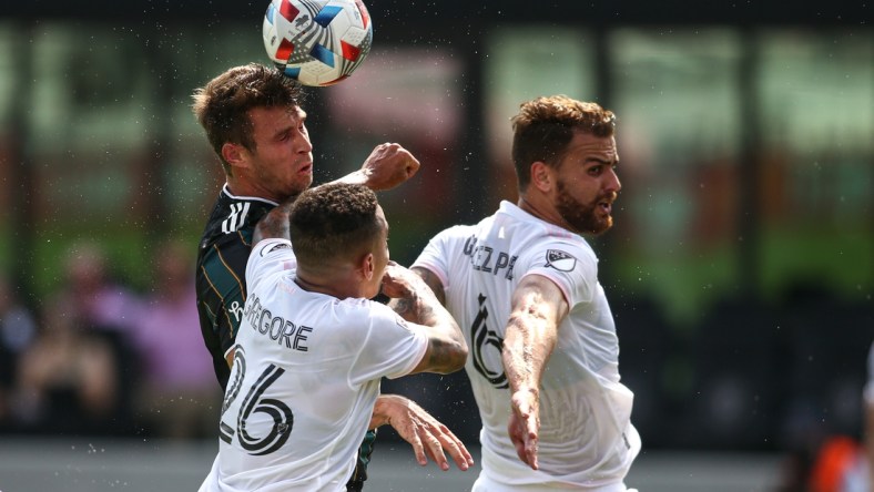 Apr 18, 2021; Fort Lauderdale, FL, USA; Los Angeles Galaxy forward Nick DePuy (20) heads the ball against Inter Miami CF midfielder Gregore (26) and midfielder Leandro Pirez (6) during the first half at DRV PNK Stadium. Mandatory Credit: Sam Navarro-USA TODAY Sports