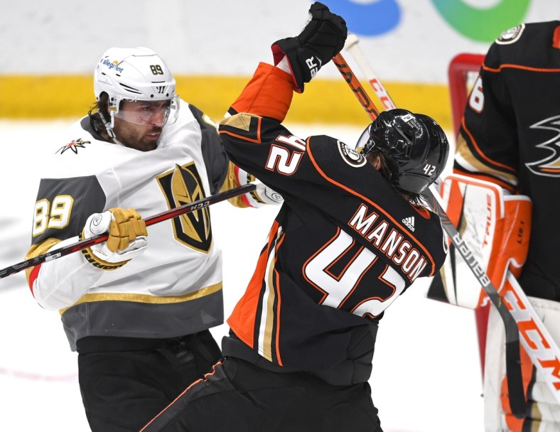 Apr 18, 2021; Anaheim, California, USA; Vegas Golden Knights right wing Alex Tuch (89) and Anaheim Ducks defenseman Josh Manson (42) battle in front of the net in the second period at Honda Center. Mandatory Credit: Jayne Kamin-Oncea-USA TODAY Sports