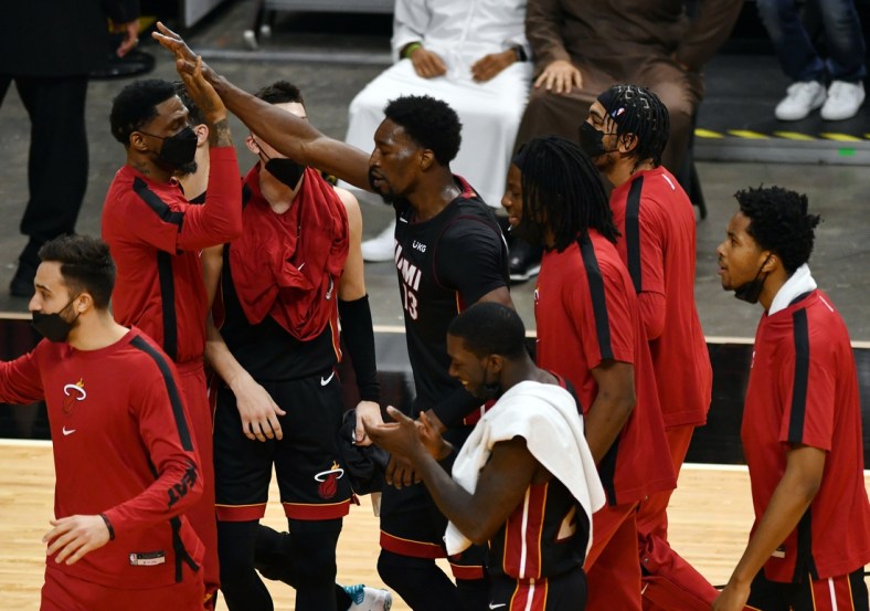 Apr 18, 2021; Miami, Florida, USA; Miami Heat center Bam Adebayo (13) celebrates a winning shot over the Brooklyn Nets with teammates at American Airlines Arena. Mandatory Credit: Jim Rassol-USA TODAY Sports