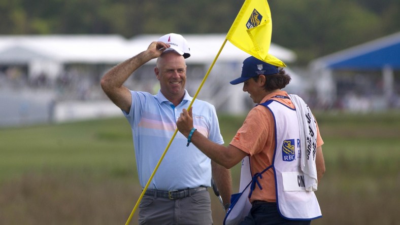 Apr 18, 2021; Hilton Head, South Carolina, USA; Stewart Cink celebrates with his caddie on the green of the eighteenth hole after winning the 2021 RBC Heritage golf tournament. Mandatory Credit: Joshua S. Kelly-USA TODAY Sports