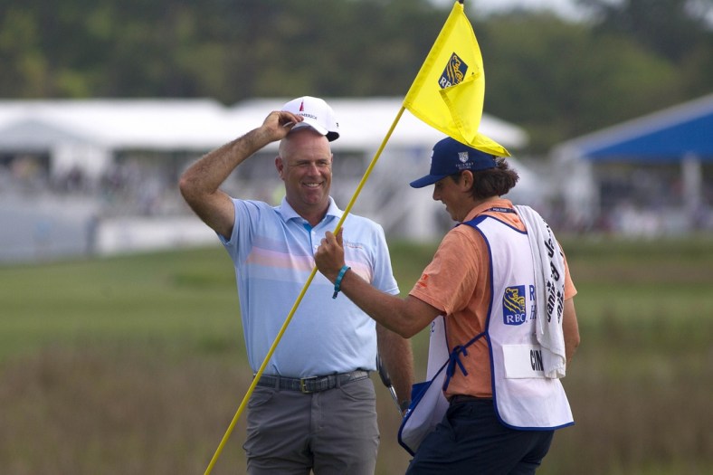 Apr 18, 2021; Hilton Head, South Carolina, USA; Stewart Cink celebrates with his caddie on the green of the eighteenth hole after winning the 2021 RBC Heritage golf tournament. Mandatory Credit: Joshua S. Kelly-USA TODAY Sports