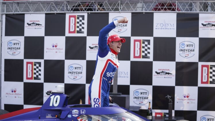 Apr 18, 2021; Birmingham, Alabama, USA; Indy driver Alex Palou (10) reacts as he climbs out of the car after winning at Barber Motorsports Park. Mandatory Credit: Marvin Gentry-USA TODAY Sports