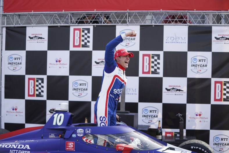 Apr 18, 2021; Birmingham, Alabama, USA; Indy driver Alex Palou (10) reacts as he climbs out of the car after winning at Barber Motorsports Park. Mandatory Credit: Marvin Gentry-USA TODAY Sports