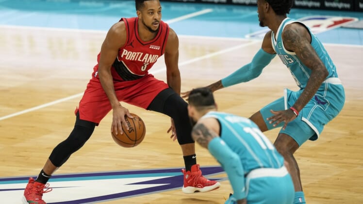 Apr 18, 2021; Charlotte, North Carolina, USA; Portland Trail Blazers guard CJ McCollum (3) brings the ball upourt defended by Charlotte Hornets forward Jalen McDaniels (6) during the first quarter at the Spectrum Center. Mandatory Credit: Jim Dedmon-USA TODAY Sports