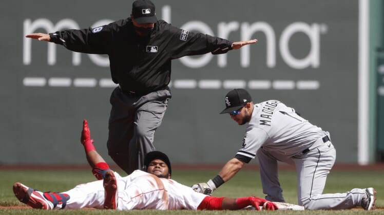 Apr 19, 2021; Boston, Massachusetts, USA; Chicago White Sox second baseman Nick Madrigal (1) applies a late tag as Boston Red Sox center fielder Franchy Cordero (16) slides safely into second after advancing on an error after a single as umpire Doug Eddings (88) makes the call during the first inning at Fenway Park. Mandatory Credit: Winslow Townson-USA TODAY Sports