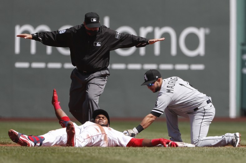 Apr 19, 2021; Boston, Massachusetts, USA; Chicago White Sox second baseman Nick Madrigal (1) applies a late tag as Boston Red Sox center fielder Franchy Cordero (16) slides safely into second after advancing on an error after a single as umpire Doug Eddings (88) makes the call during the first inning at Fenway Park. Mandatory Credit: Winslow Townson-USA TODAY Sports