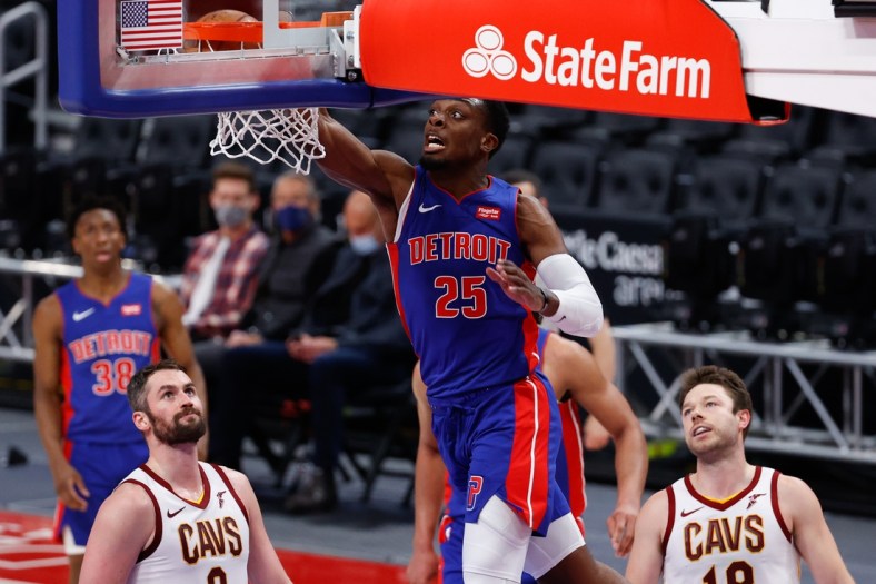 Apr 19, 2021; Detroit, Michigan, USA;  Detroit Pistons forward Tyler Cook (25) dunks on Cleveland Cavaliers forward Kevin Love (0) and guard Matthew Dellavedova (18) in the first half at Little Caesars Arena. Mandatory Credit: Rick Osentoski-USA TODAY Sports
