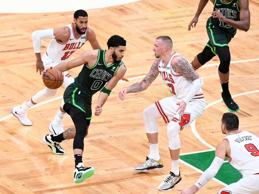 Apr 19, 2021; Boston, Massachusetts, USA; Boston Celtics forward Jayson Tatum (0) drives to the basket Chicago Bulls center Daniel Theis (27) during the first half at the TD Garden. Mandatory Credit: Brian Fluharty-USA TODAY Sports