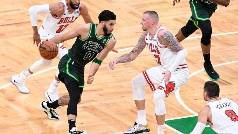 Apr 19, 2021; Boston, Massachusetts, USA; Boston Celtics forward Jayson Tatum (0) drives to the basket Chicago Bulls center Daniel Theis (27) during the first half at the TD Garden. Mandatory Credit: Brian Fluharty-USA TODAY Sports