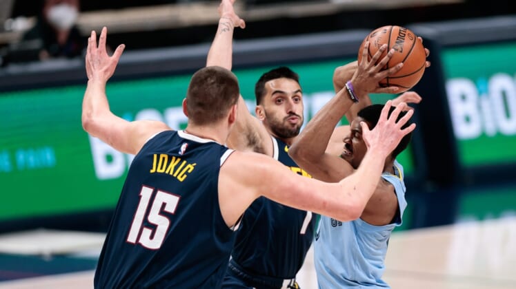 Apr 19, 2021; Denver, Colorado, USA; Memphis Grizzlies guard De'Anthony Melton (0) looks to pass the ball under pressure from Denver Nuggets center Nikola Jokic (15) and guard Facundo Campazzo (7) in the first quarter at Ball Arena. Mandatory Credit: Isaiah J. Downing-USA TODAY Sports