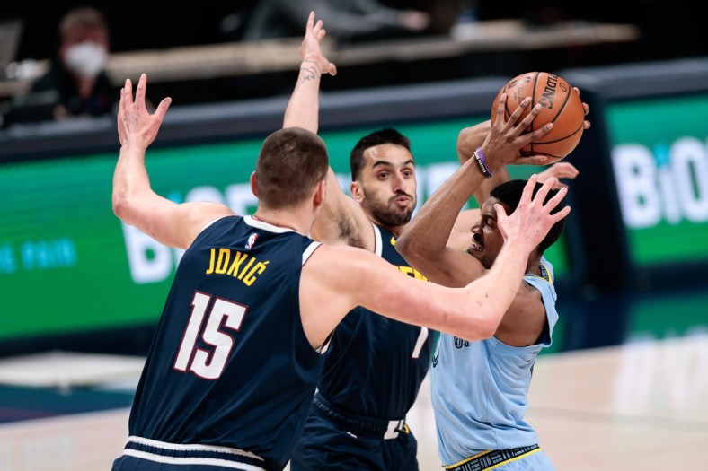 Apr 19, 2021; Denver, Colorado, USA; Memphis Grizzlies guard De'Anthony Melton (0) looks to pass the ball under pressure from Denver Nuggets center Nikola Jokic (15) and guard Facundo Campazzo (7) in the first quarter at Ball Arena. Mandatory Credit: Isaiah J. Downing-USA TODAY Sports