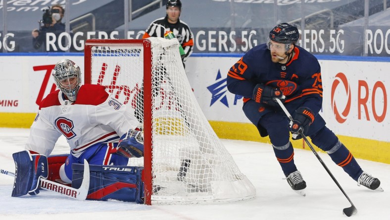 Apr 19, 2021; Edmonton, Alberta, CAN; Edmonton Oilers forward Leon Draisaitl (29) moves the puck behind Montreal Canadiens goaltender Carey Price (31) during the first period at Rogers Place. Mandatory Credit: Perry Nelson-USA TODAY Sports