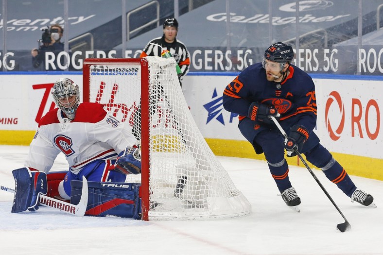 Apr 19, 2021; Edmonton, Alberta, CAN; Edmonton Oilers forward Leon Draisaitl (29) moves the puck behind Montreal Canadiens goaltender Carey Price (31) during the first period at Rogers Place. Mandatory Credit: Perry Nelson-USA TODAY Sports