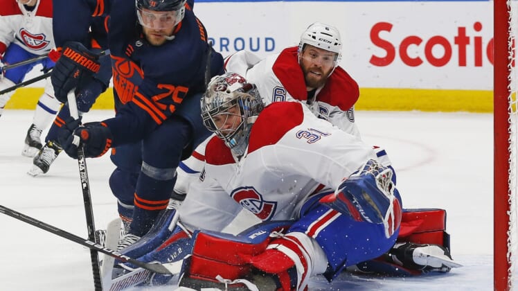 Apr 19, 2021; Edmonton, Alberta, CAN; Montreal Canadiens goaltender Carey Price (31) makes a save on Edmonton Oilers forward Leon Draisaitl (29) during the first period at Rogers Place. Mandatory Credit: Perry Nelson-USA TODAY Sports
