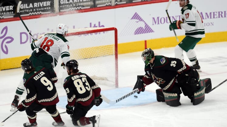 Apr 19, 2021; Glendale, Arizona, USA; Minnesota Wild left wing Jordan Greenway (18) scores a goal against Arizona Coyotes goaltender Darcy Kuemper (35) during the second period at Gila River Arena. Mandatory Credit: Joe Camporeale-USA TODAY Sports