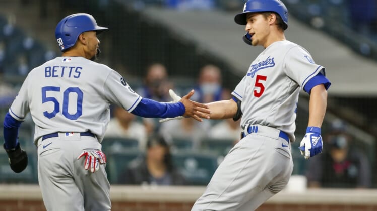 Apr 19, 2021; Seattle, Washington, USA; Los Angeles Dodgers shortstop Corey Seager (5) greets center fielder Mookie Betts (50) after hitting a two-run home run against the Seattle Mariners during the third inning at T-Mobile Park. Betts scored a run on the hit. Mandatory Credit: Joe Nicholson-USA TODAY Sports