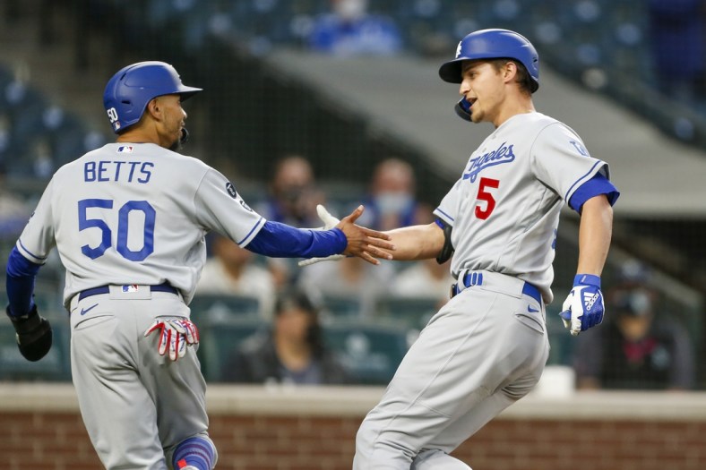Apr 19, 2021; Seattle, Washington, USA; Los Angeles Dodgers shortstop Corey Seager (5) greets center fielder Mookie Betts (50) after hitting a two-run home run against the Seattle Mariners during the third inning at T-Mobile Park. Betts scored a run on the hit. Mandatory Credit: Joe Nicholson-USA TODAY Sports