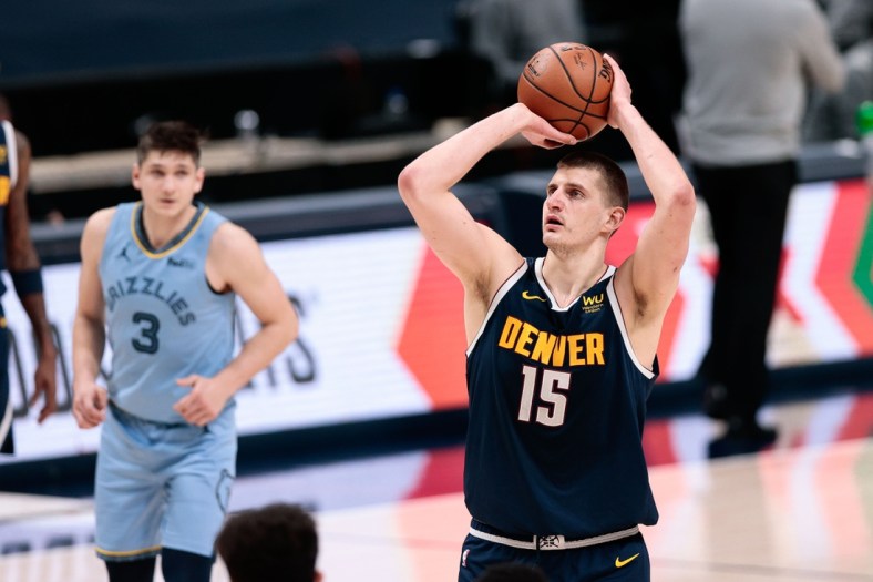 Apr 19, 2021; Denver, Colorado, USA; Denver Nuggets center Nikola Jokic (15) attempts a free throw in the fourth quarter against the Memphis Grizzlies at Ball Arena. Mandatory Credit: Isaiah J. Downing-USA TODAY Sports