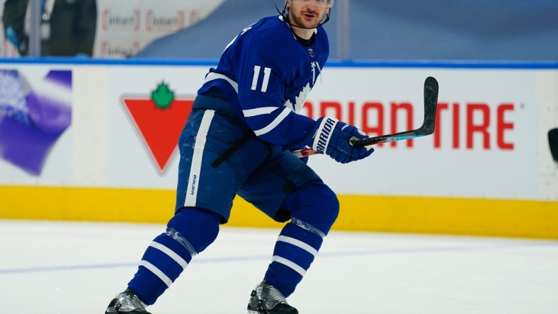 Apr 13, 2021; Toronto, Ontario, CAN; Toronto Maple Leafs forward Zach Hyman (11) skates against the Calgary Flames during the first period at Scotiabank Arena. Mandatory Credit: John E. Sokolowski-USA TODAY Sports